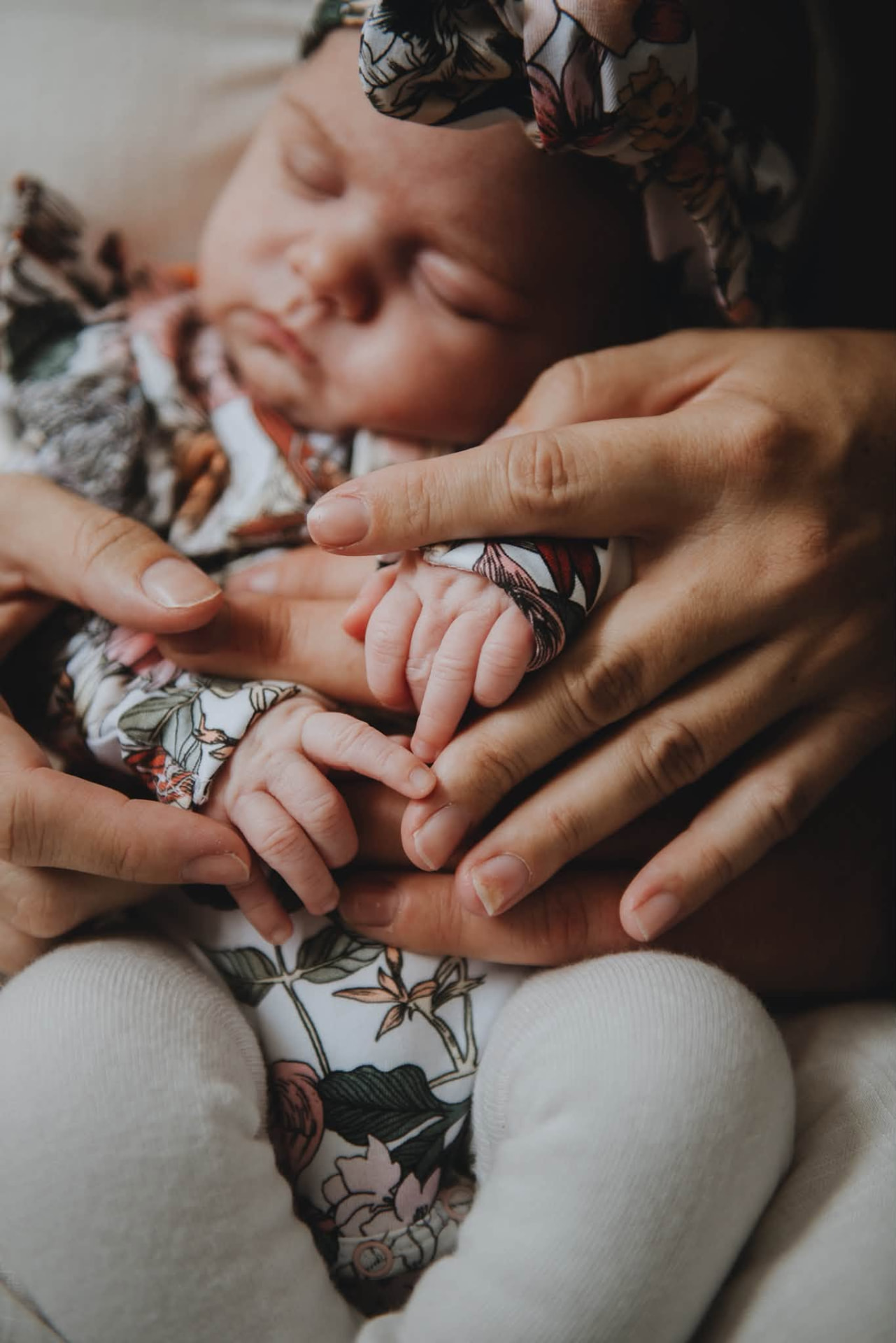 Newborn holding a parent's finger